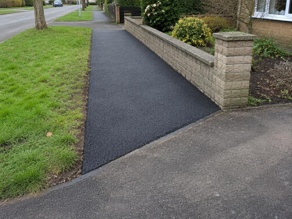 Hand laid footway beside a residential boundary